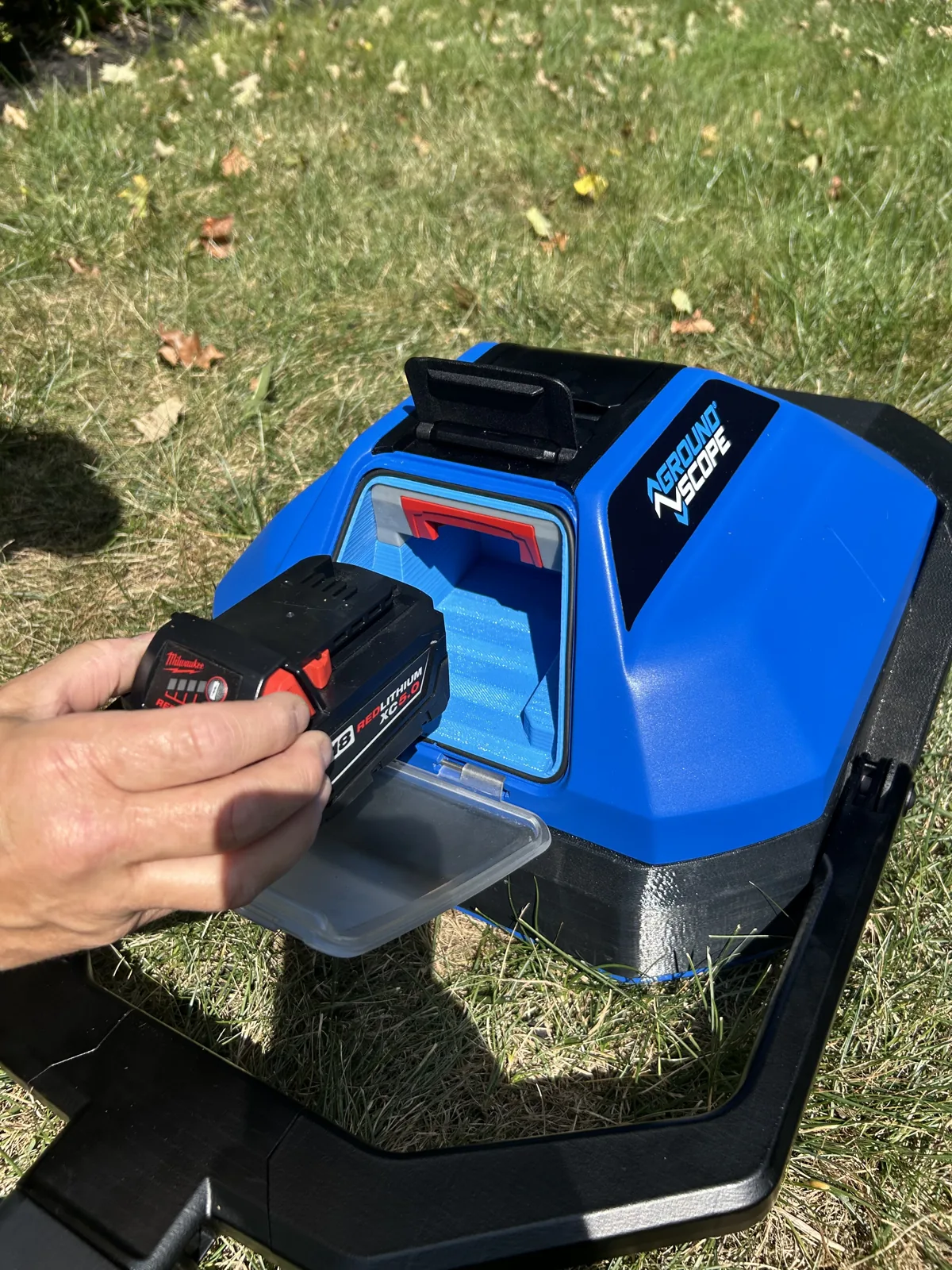 A Milwaukee M18 battery going into the unit